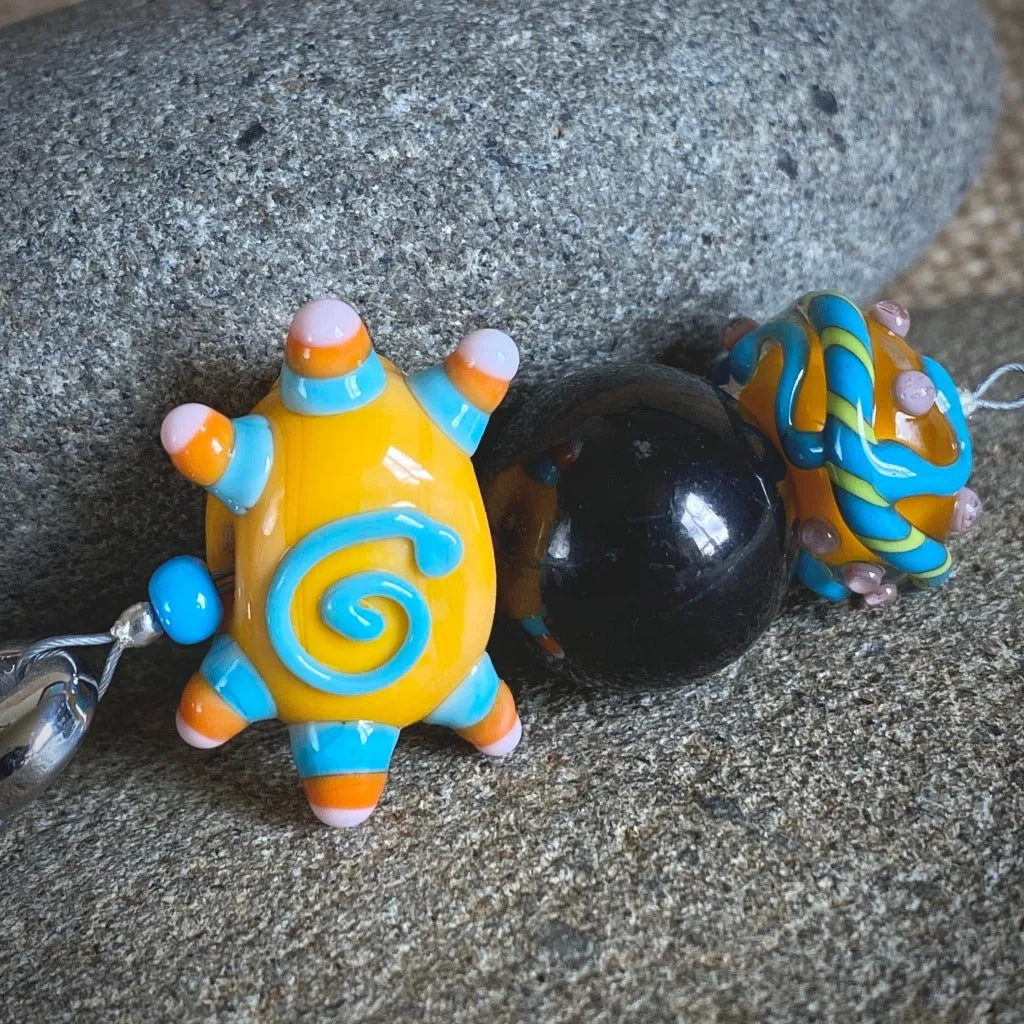 Shungite Clip-on, Necklace, Whimsical Orange Sun Face, Lampwork Glass